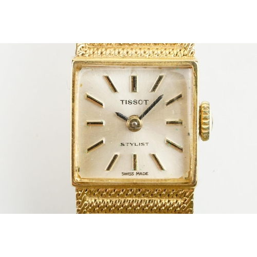 521 - Tissot stylist 9ct gold ladies cocktail watch. The watch having a square face with baton markers to ... 