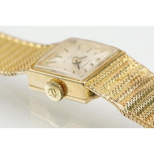 521 - Tissot stylist 9ct gold ladies cocktail watch. The watch having a square face with baton markers to ... 