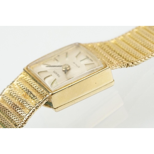 521 - Tissot stylist 9ct gold ladies cocktail watch. The watch having a square face with baton markers to ... 