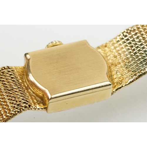 521 - Tissot stylist 9ct gold ladies cocktail watch. The watch having a square face with baton markers to ... 