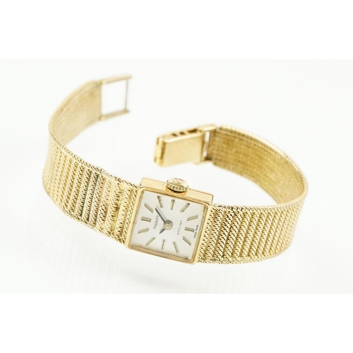 521 - Tissot stylist 9ct gold ladies cocktail watch. The watch having a square face with baton markers to ... 