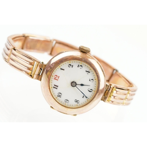 527 - Early 20th Century 9ct gold hallmarked wrist watch. The watch having a round white enamelled face wi... 