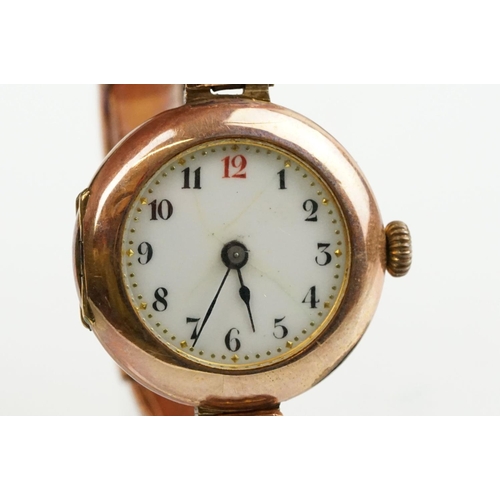 527 - Early 20th Century 9ct gold hallmarked wrist watch. The watch having a round white enamelled face wi... 