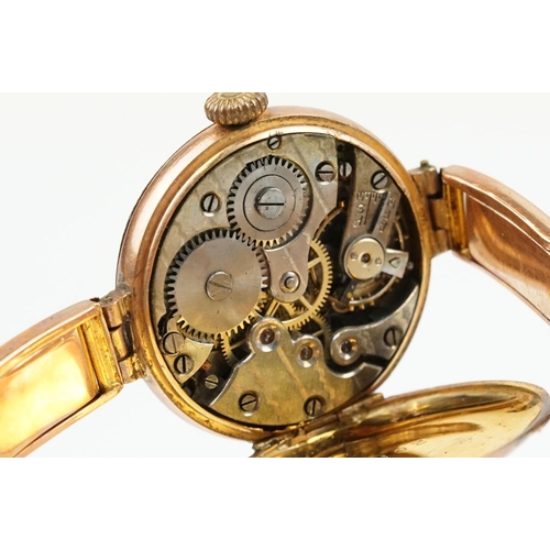 527 - Early 20th Century 9ct gold hallmarked wrist watch. The watch having a round white enamelled face wi... 