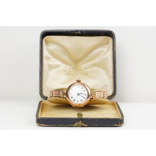 527 - Early 20th Century 9ct gold hallmarked wrist watch. The watch having a round white enamelled face wi... 