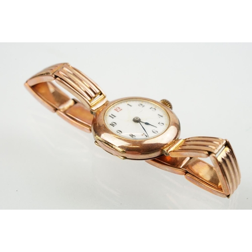 527 - Early 20th Century 9ct gold hallmarked wrist watch. The watch having a round white enamelled face wi... 