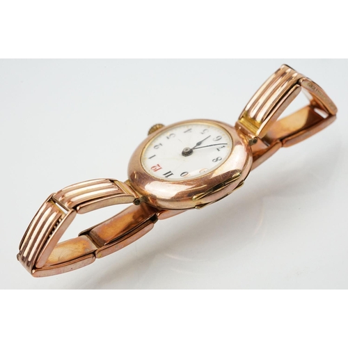 527 - Early 20th Century 9ct gold hallmarked wrist watch. The watch having a round white enamelled face wi... 