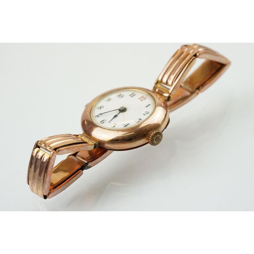 527 - Early 20th Century 9ct gold hallmarked wrist watch. The watch having a round white enamelled face wi... 