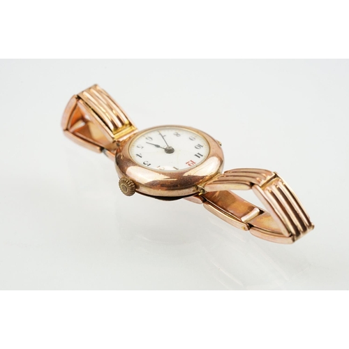 527 - Early 20th Century 9ct gold hallmarked wrist watch. The watch having a round white enamelled face wi... 