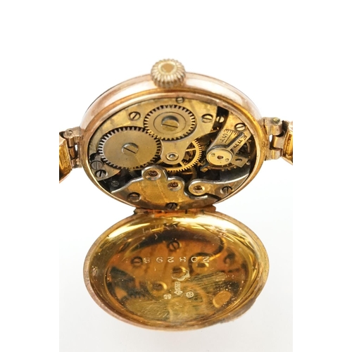 527 - Early 20th Century 9ct gold hallmarked wrist watch. The watch having a round white enamelled face wi... 