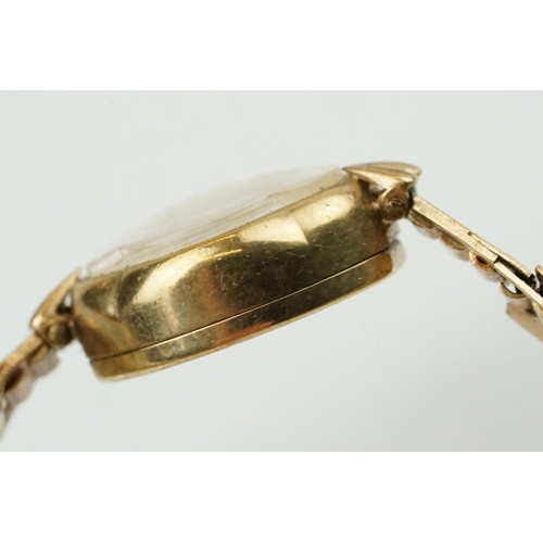 543 - 9ct gold cocktail watch having an oval face with baton markings to the chapter ring on a 9ct gold br... 