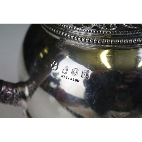 587 - Irish hot water pot silver having moulded Celtic design borders raised on scrolled feet, having a ca... 