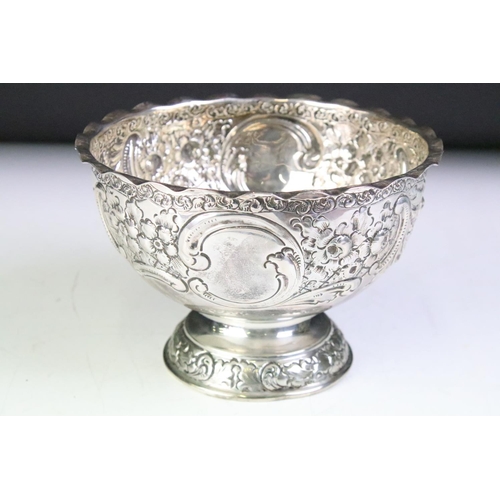 596 - 19th Century Victorian silver hallmarked footed bowl having repousse floral and scrolled detailing r... 