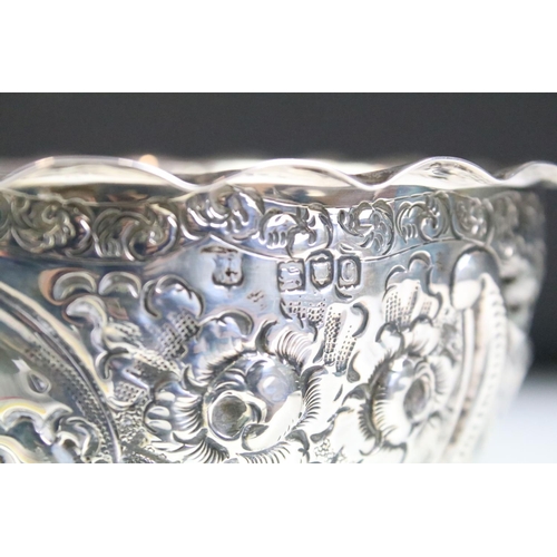 596 - 19th Century Victorian silver hallmarked footed bowl having repousse floral and scrolled detailing r... 