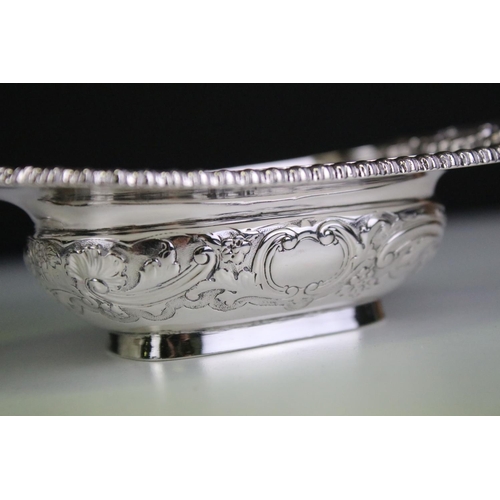 624 - Pair of late Victorian heavy silver salt cellars, with repousse scrolling decoration and cast decora... 