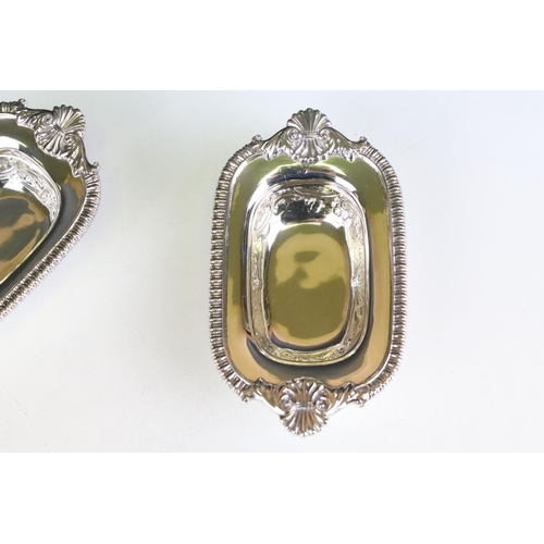 624 - Pair of late Victorian heavy silver salt cellars, with repousse scrolling decoration and cast decora... 