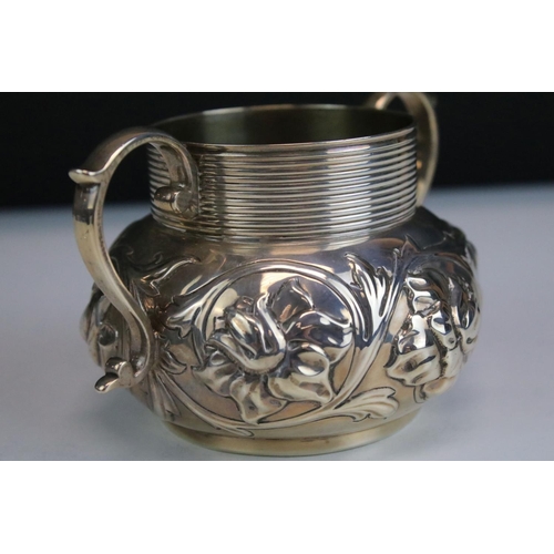 630 - Hancocks & Co - A late Victorian silver sugar bowl, twin-handled, with repousse floral & scrolling f... 