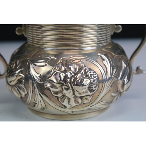 630 - Hancocks & Co - A late Victorian silver sugar bowl, twin-handled, with repousse floral & scrolling f... 