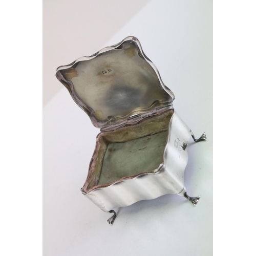 631 - Asprey of London - A silver jewellery box / casket of shaped form, with fitted interior, raised on f... 