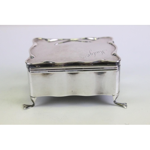 631 - Asprey of London - A silver jewellery box / casket of shaped form, with fitted interior, raised on f... 