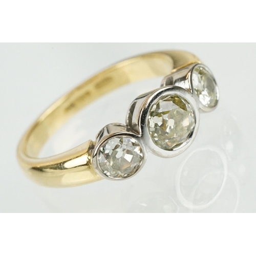 283 - 18ct gold and diamond three stone ring. The ring having three round old cut diamonds in bezel settin... 