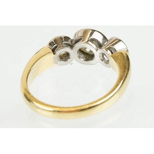 283 - 18ct gold and diamond three stone ring. The ring having three round old cut diamonds in bezel settin... 