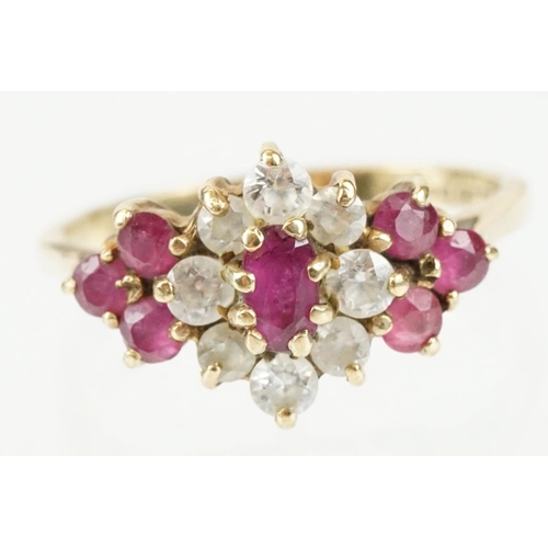 59 - Hallmarked 9ct gold ruby and white stone cluster ring. The ring being set with an oval cut ruby to c... 