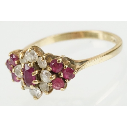 59 - Hallmarked 9ct gold ruby and white stone cluster ring. The ring being set with an oval cut ruby to c... 