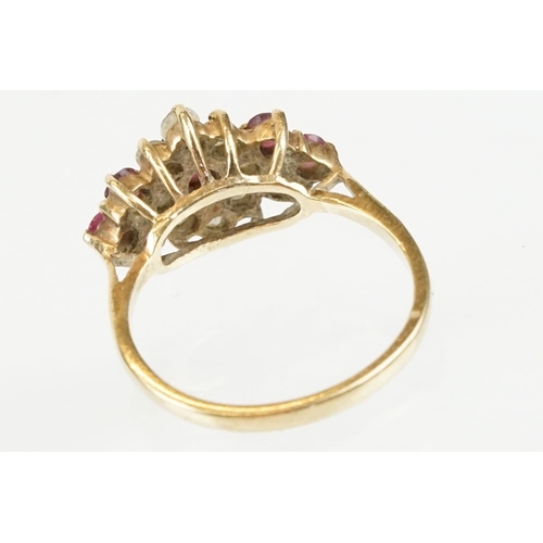 59 - Hallmarked 9ct gold ruby and white stone cluster ring. The ring being set with an oval cut ruby to c... 