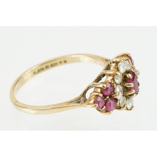 59 - Hallmarked 9ct gold ruby and white stone cluster ring. The ring being set with an oval cut ruby to c... 