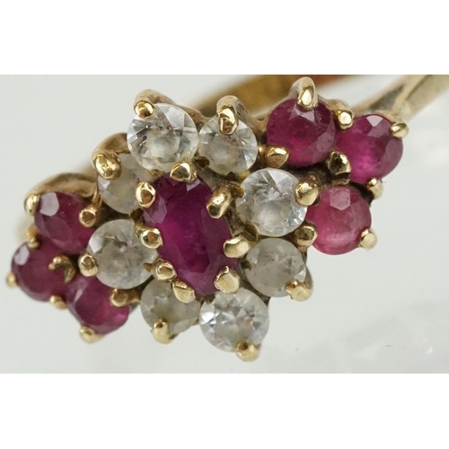 59 - Hallmarked 9ct gold ruby and white stone cluster ring. The ring being set with an oval cut ruby to c... 