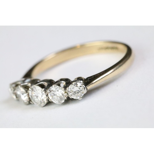 320A - 18ct gold and diamond five stone ring being set with five graduating round brilliant cut diamonds. B... 