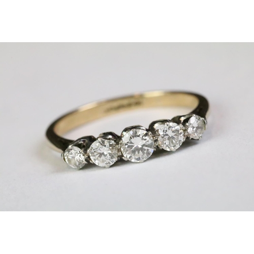 320A - 18ct gold and diamond five stone ring being set with five graduating round brilliant cut diamonds. B... 