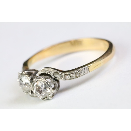 330A - 18ct gold and diamond moi et toi ring. The ring being set with two old cut diamonds with further dia... 