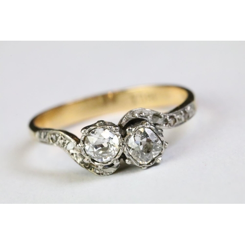 330A - 18ct gold and diamond moi et toi ring. The ring being set with two old cut diamonds with further dia... 