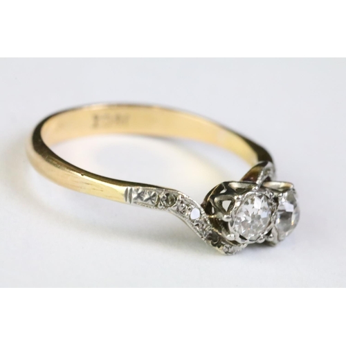 330A - 18ct gold and diamond moi et toi ring. The ring being set with two old cut diamonds with further dia... 