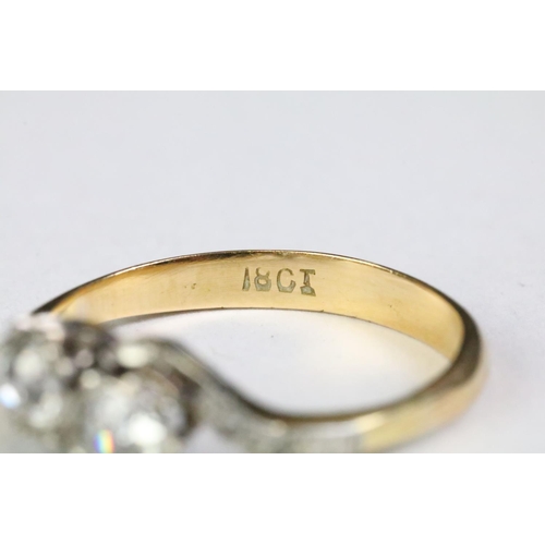 330A - 18ct gold and diamond moi et toi ring. The ring being set with two old cut diamonds with further dia... 