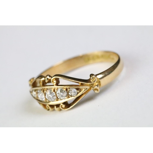 350A - 18ct gold and diamond five stone ring being set with five round old cut diamonds within a scrolled d... 