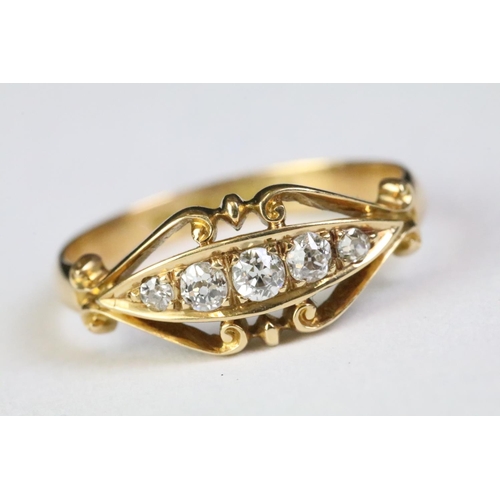 350A - 18ct gold and diamond five stone ring being set with five round old cut diamonds within a scrolled d... 