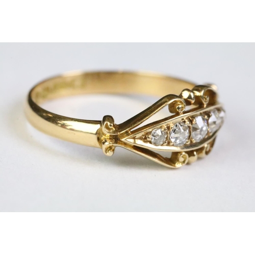 350A - 18ct gold and diamond five stone ring being set with five round old cut diamonds within a scrolled d... 