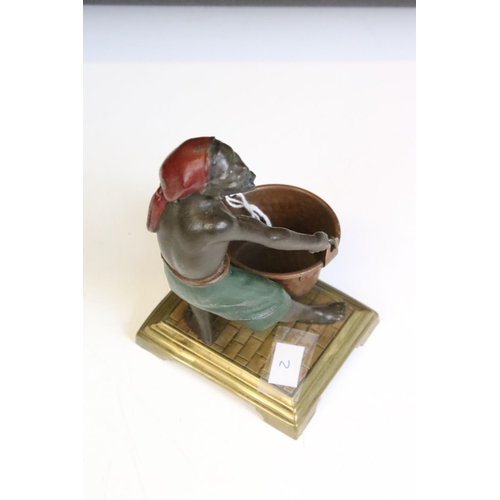 141 - Spelter polychrome figure of a man with bucket, on brass base. Approx 14.5cm high