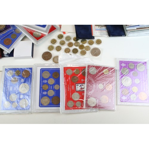 245 - A large collection of British Royal mint uncirculated coin sets to include £1, 50p and £2 examples t... 