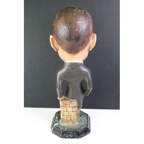 134 - London Aristos Caps Art Deco chalkware shop display figurine in the form of a gentleman leaning on a... 