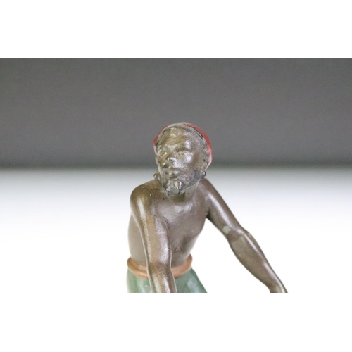 141 - Spelter polychrome figure of a man with bucket, on brass base. Approx 14.5cm high