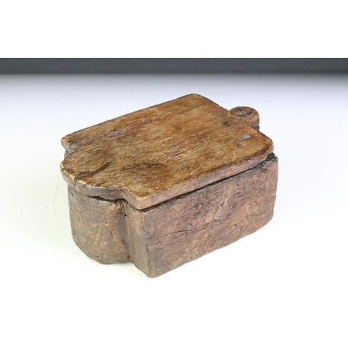 145 - Indian carved wooden spice box with pivoting lid and twin compartment interior. Approx 20cm long