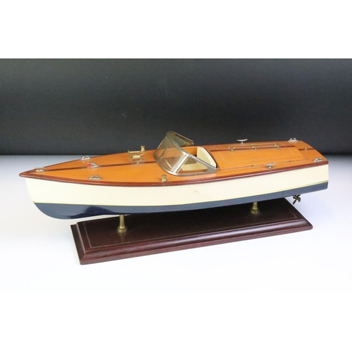 148 - Painted wooden model of a speedboat, raised on a rectangular base, approx 48cm long