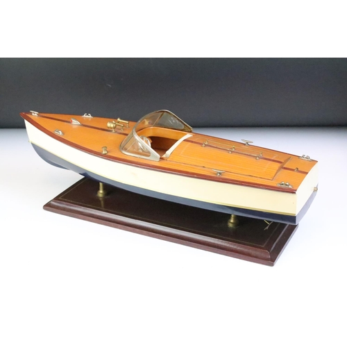 148 - Painted wooden model of a speedboat, raised on a rectangular base, approx 48cm long