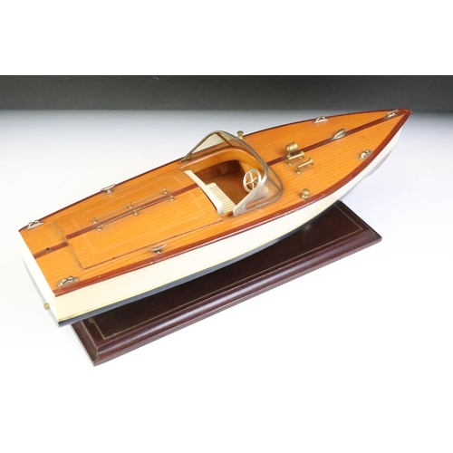 148 - Painted wooden model of a speedboat, raised on a rectangular base, approx 48cm long