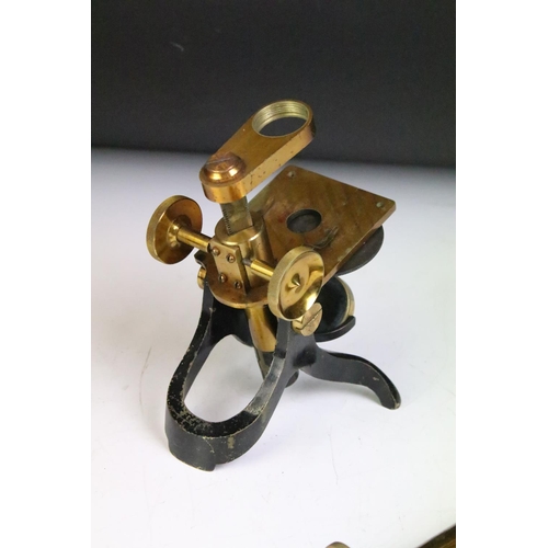 165 - Early 20th century gilt brass microscope raised on a black painted y-shaped foot, housed within a ca... 