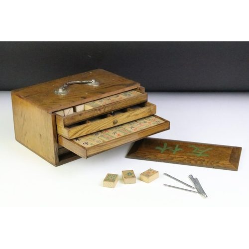 178 - Chinese mahjong set with wooden tiles and metal playing pieces, housed within trays in a wooden case... 